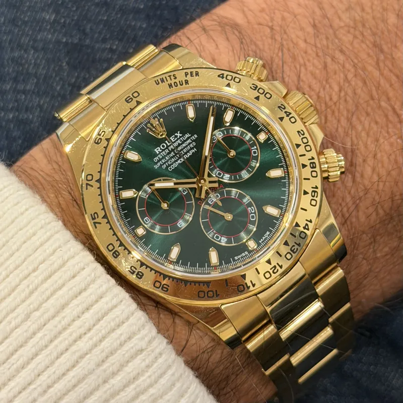 Yellow-gold Daytona 116508 with green dial on the wrist