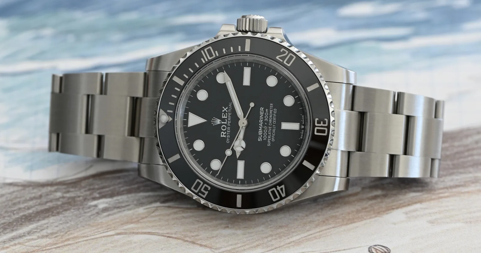 Steel dive watch on a sketched beach, with snorkel gear drawn below