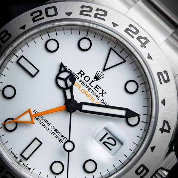 Dial close-up: orange GMT hand, date and bezel
